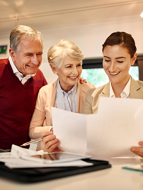 A care professional reviewing plans with two older adults
